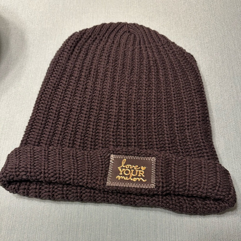Black Love Your Melon cuffed beanie with gold foil patch.